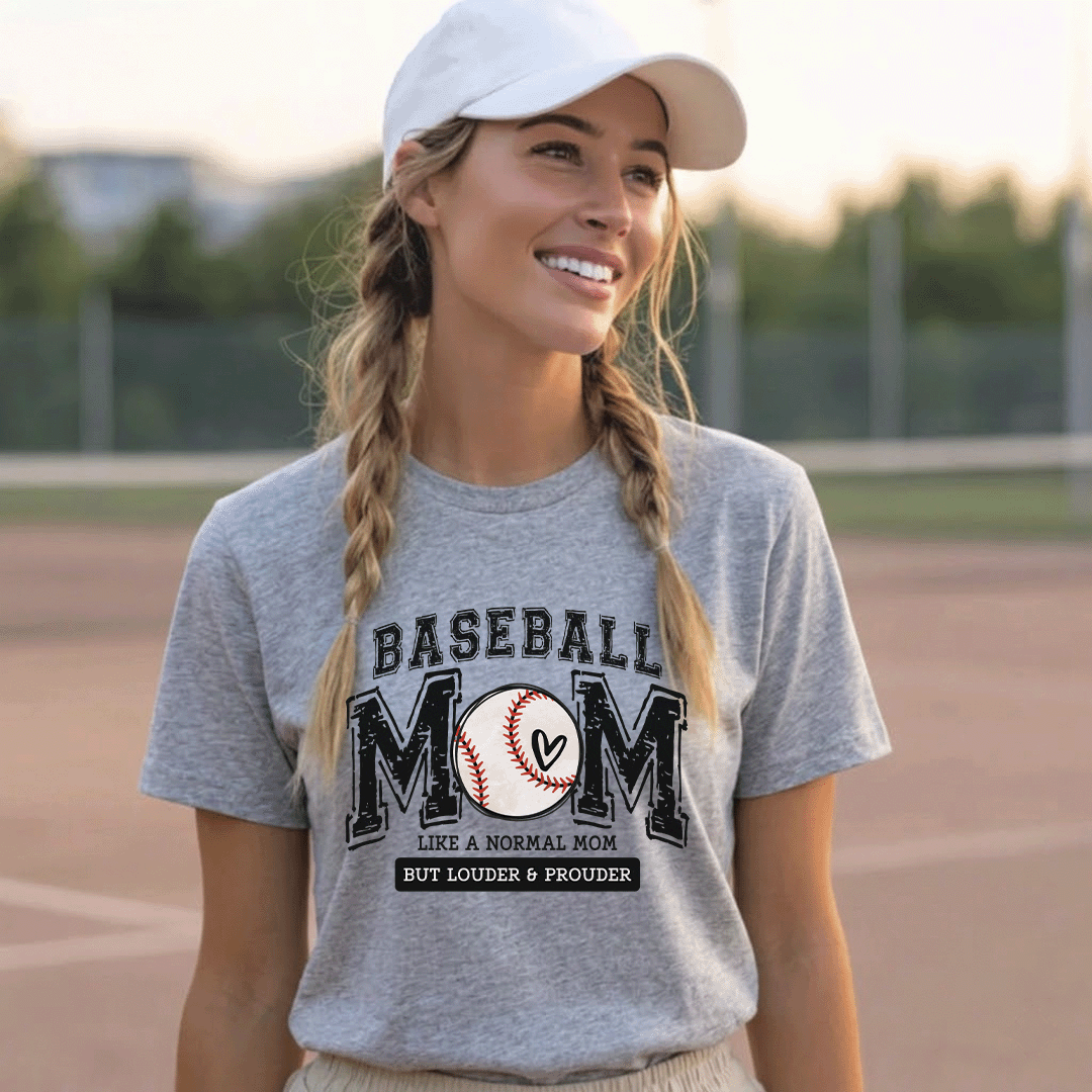 Woman wearing a white "Baseball Mom: Like a Normal Mom But Louder & Prouder" t-shirt at a baseball field