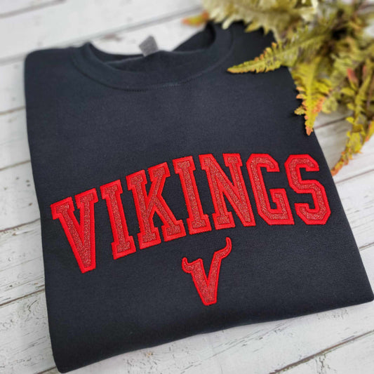 Black crewneck sweashirt with red glitter embroidery featuring the Petersburg Vikings