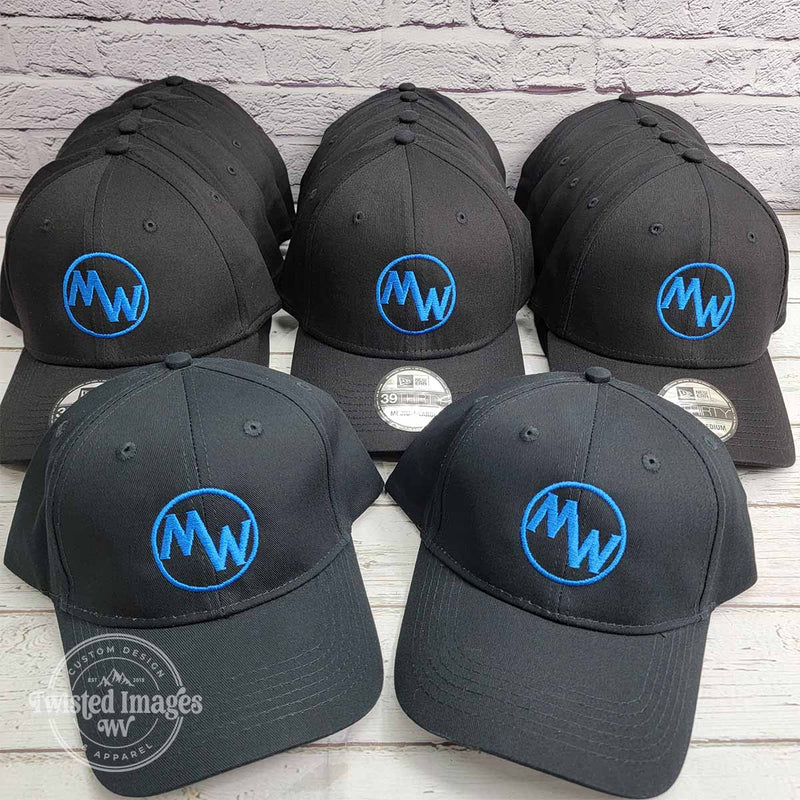 Set of custom embroidered black Flexfit hats featuring blue Mayles Welding logo stitched on front center of structured caps