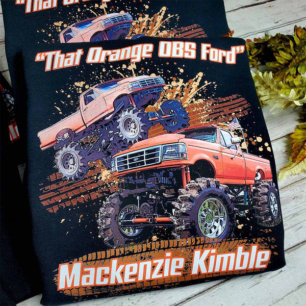 Custom printed t-shirt featuring a lifted orange OBS Ford monster truck with client name and full color background design