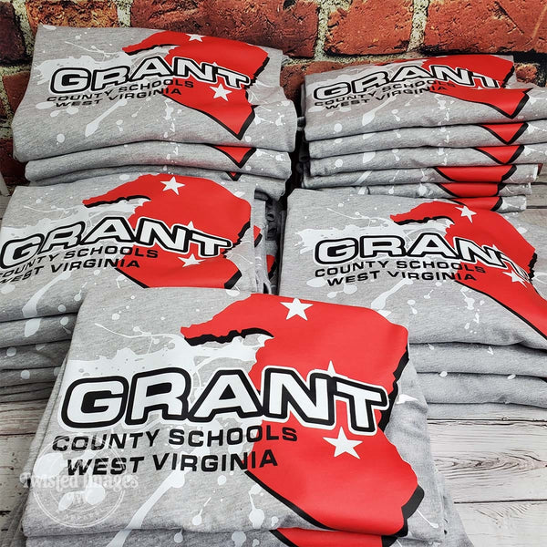Custom printed gray t-shirts for Grant County Schools in West Virginia featuring bold red state graphic with white star accents and splatter background