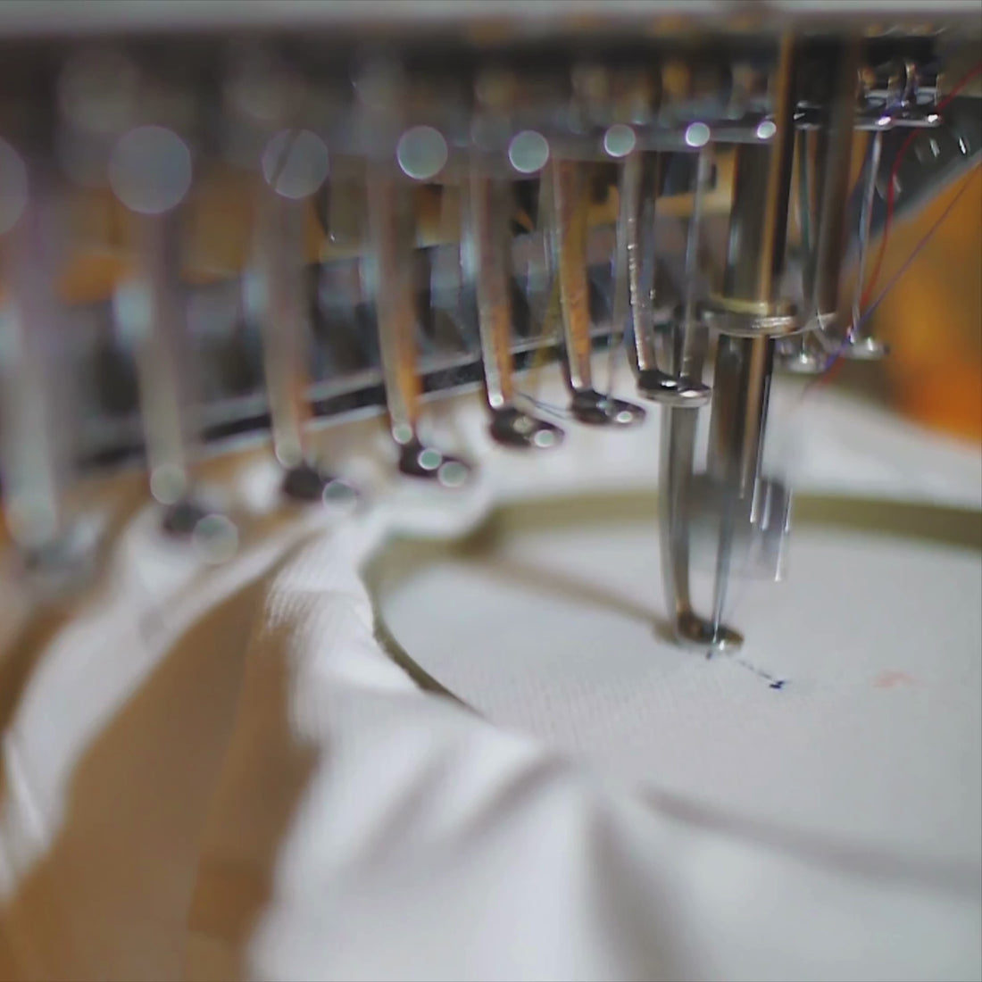 Close-up video of the needles of an embroidery machine during an embroidery project. 