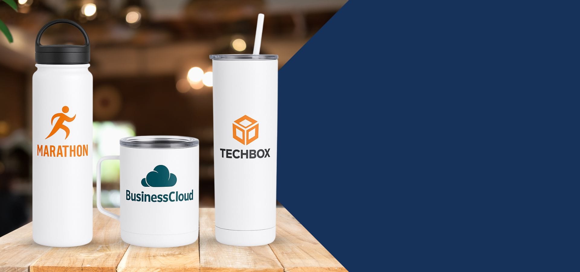  Custom tumblers and mugs with business logos on a wooden table.